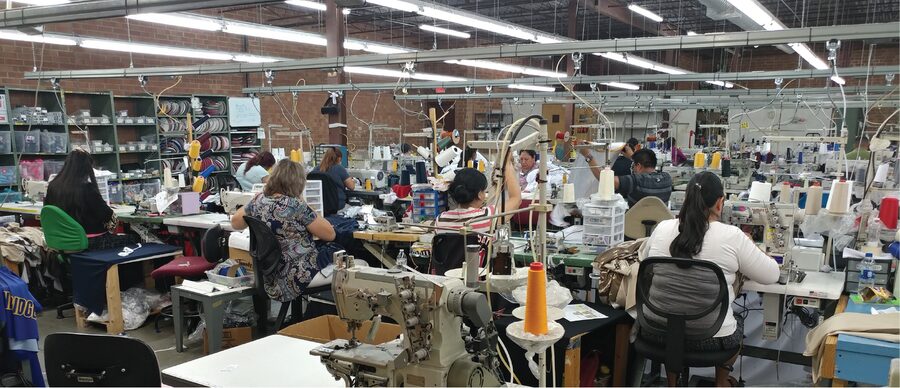 The sewing floor at OT Sports in Burlington, two rows of operators at machines
