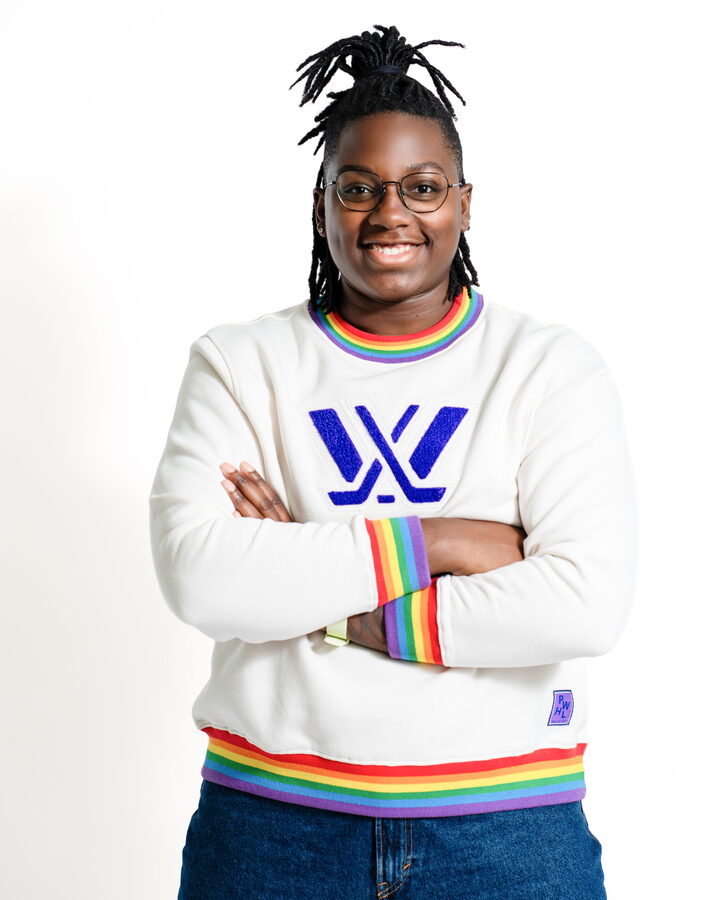 The PWHL Pride crewneck with rainbow ribbed trim and a chenille PWHL crest
