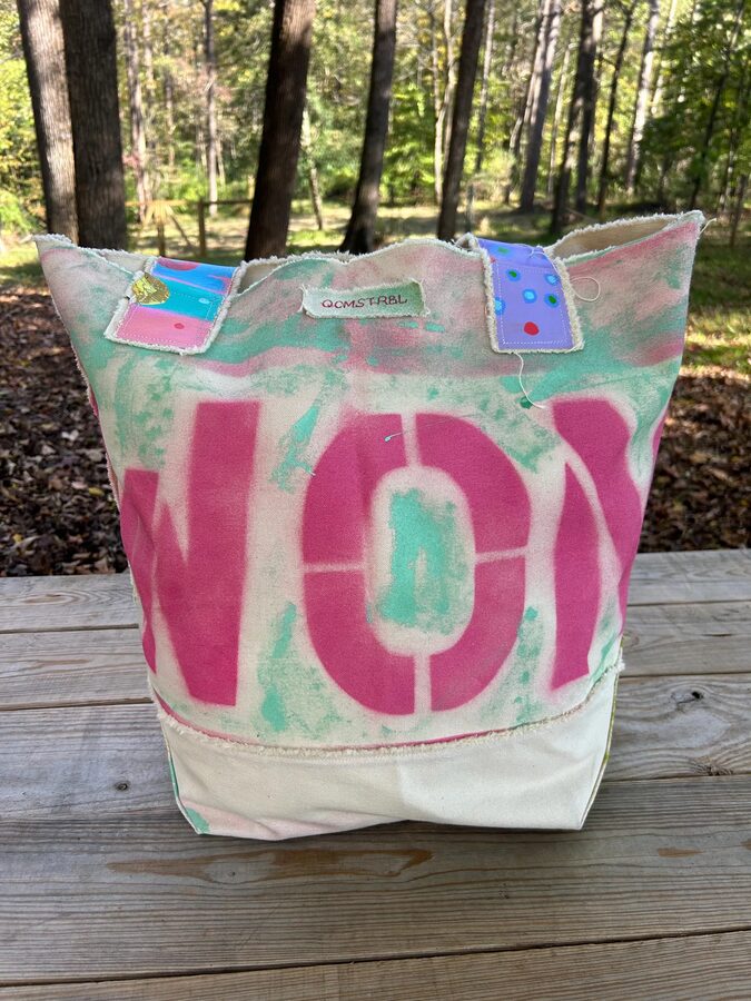 Upcycled canvas patchwork tote with spray-stencil lettering and raw-edge applique
