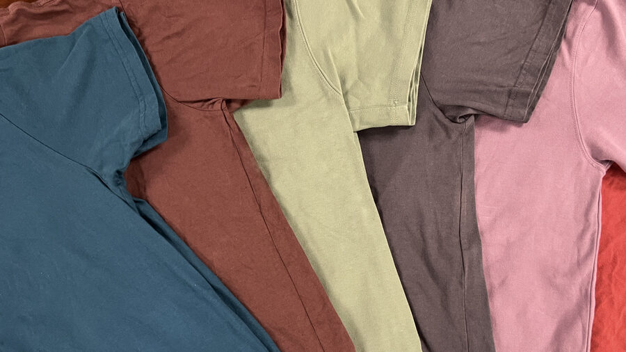 A fan of garment-dyed tees in teal, rust, butter, mauve and pink